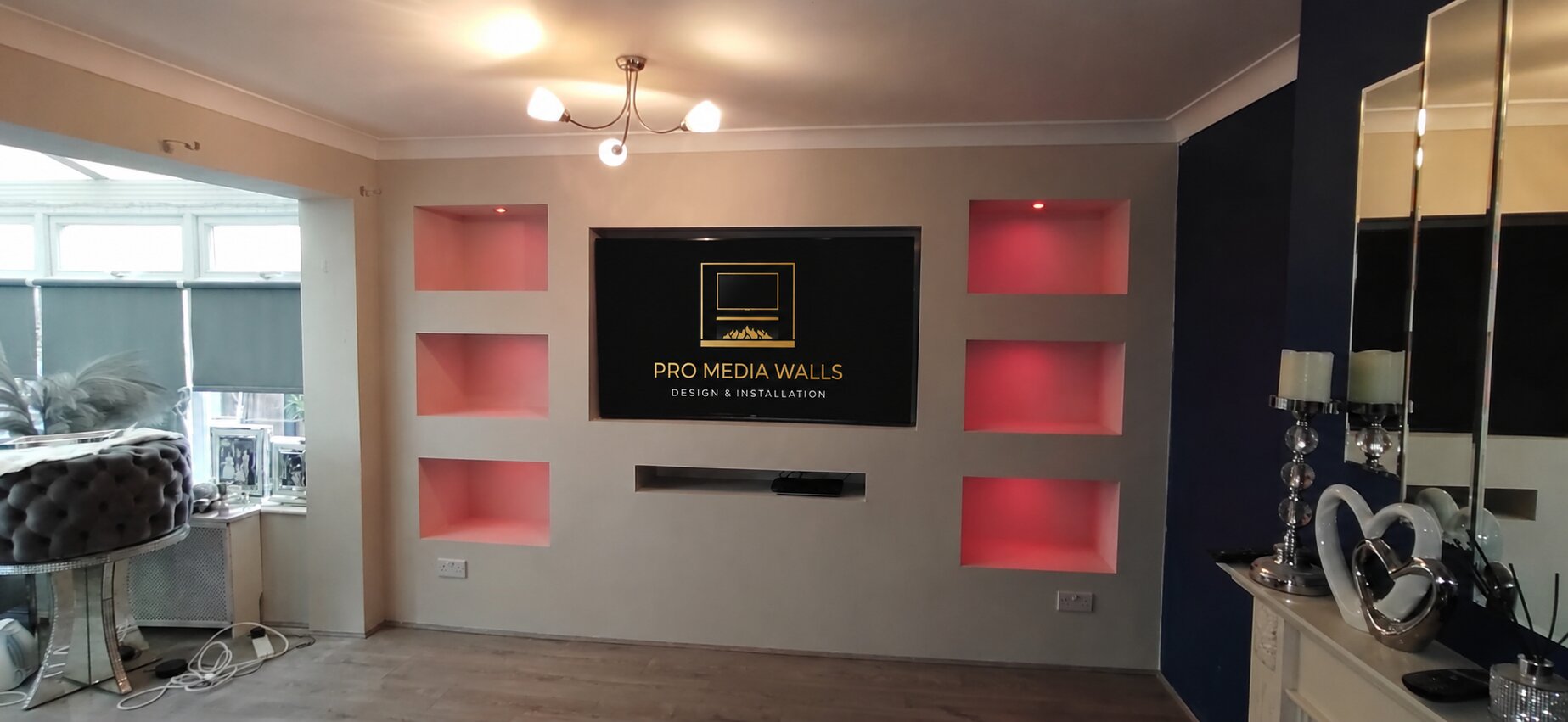 Finished bespoke media wall with fireplace, television recess and ambient lighting
