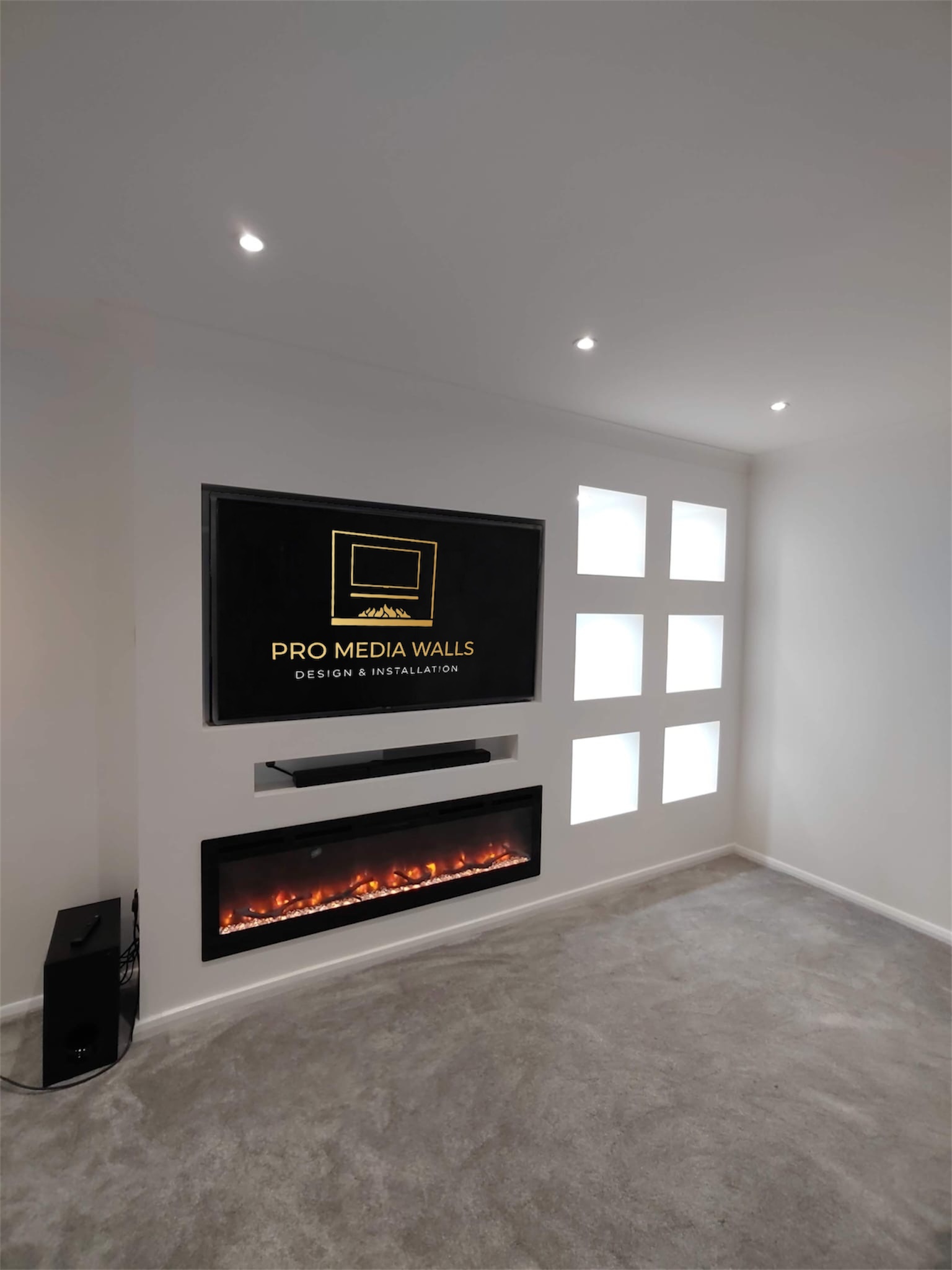Family living room media wall with shelving and integrated storage cupboards