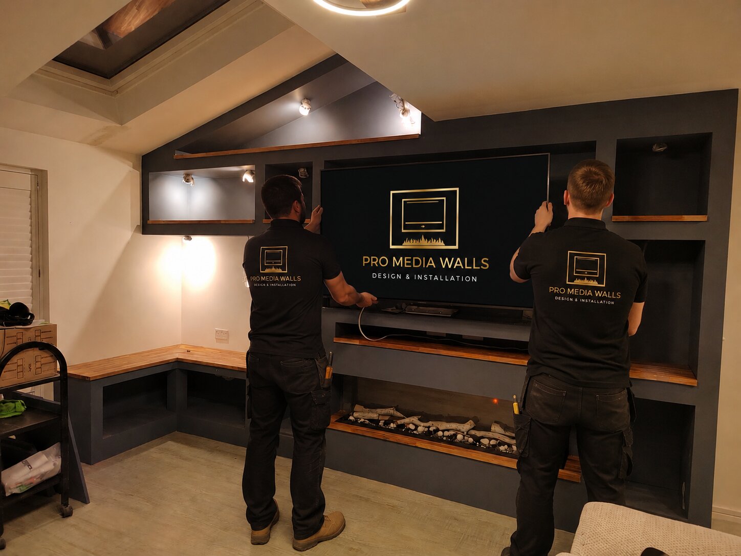 Pro Media Walls installation team fitting a premium media wall in a customer's home